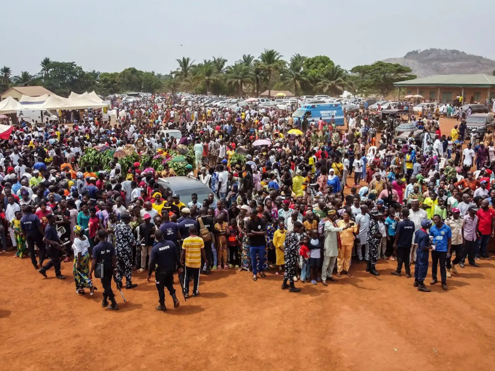 Crowd of festival attendees dancing with raised arms at Tuk-Ham celebration